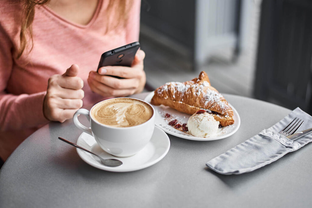 The best apps to your next trip Woman Have Breakfast In Caffe And Using Smartphone 2022 01 29 00 32 37 Utc 1024x683